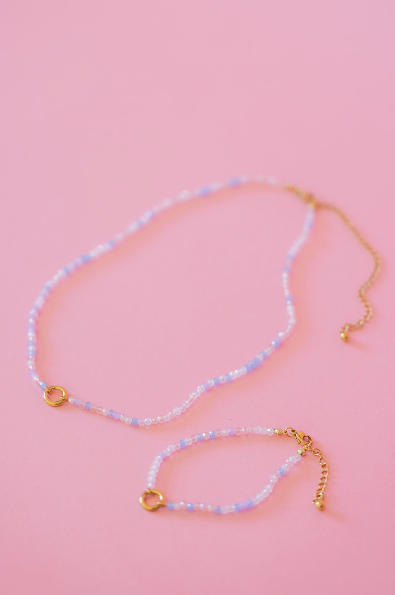 Necklace with beaded chain on a pink background