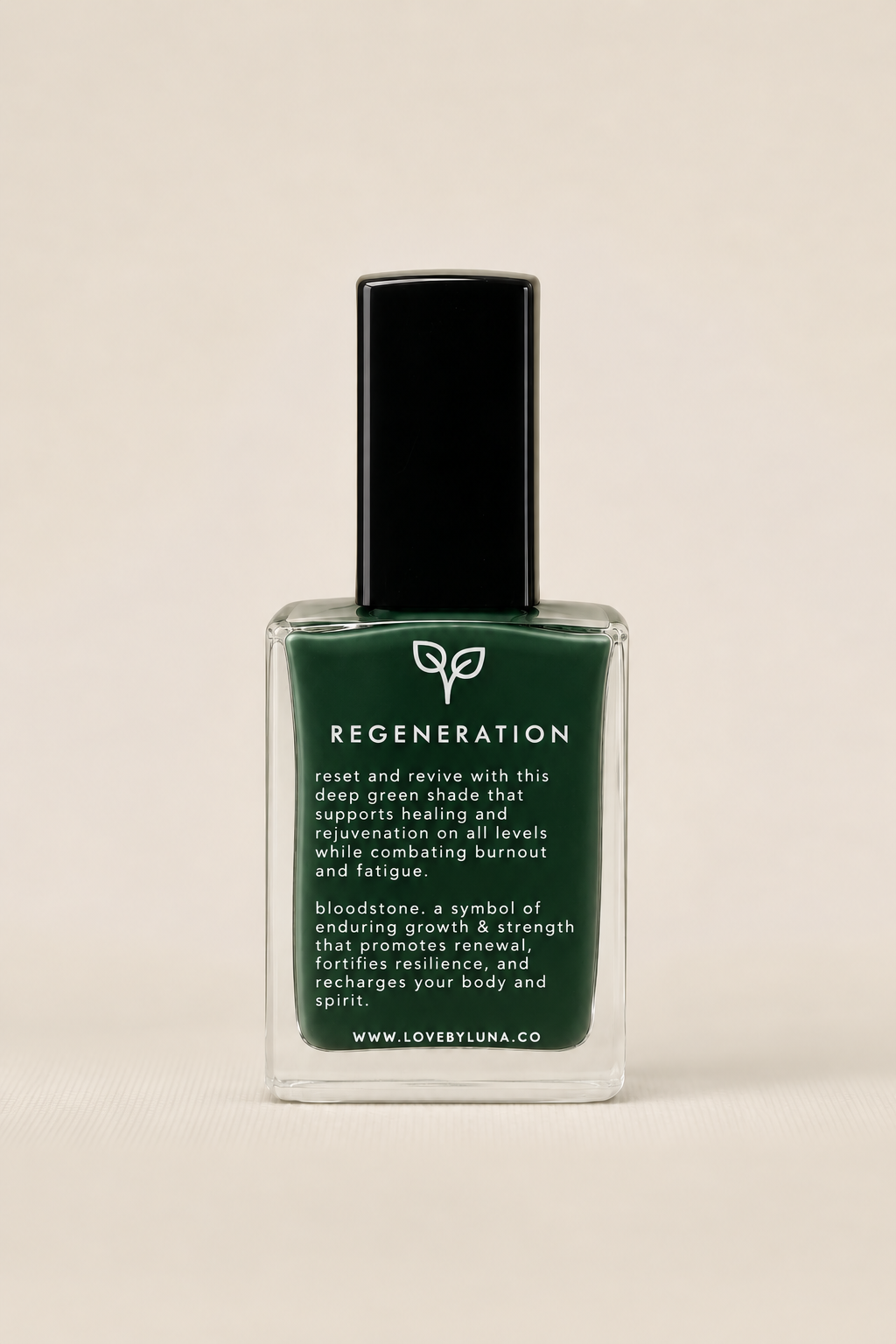 A bottle of Love is Luna Regeneration nail polish in a deep green shade, featuring a black cap and clear glass bottle, set against a solid light beige background.
