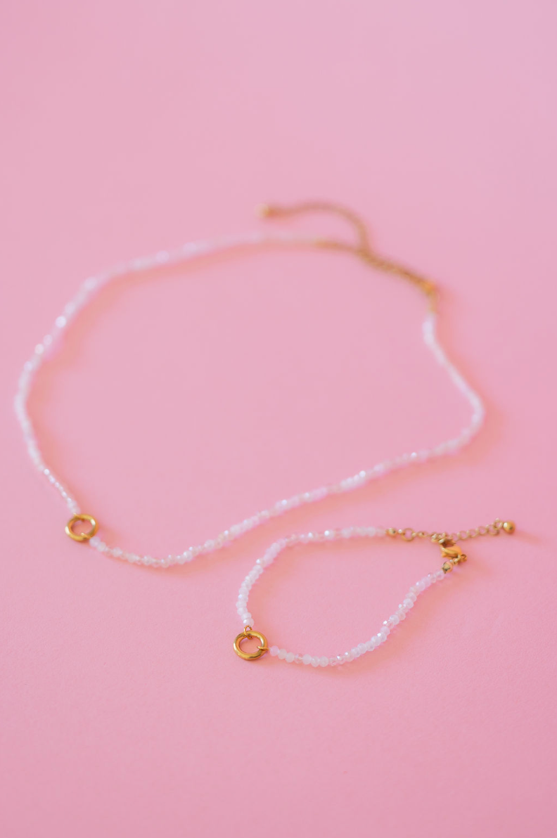 Necklace with gold accents on a pink background