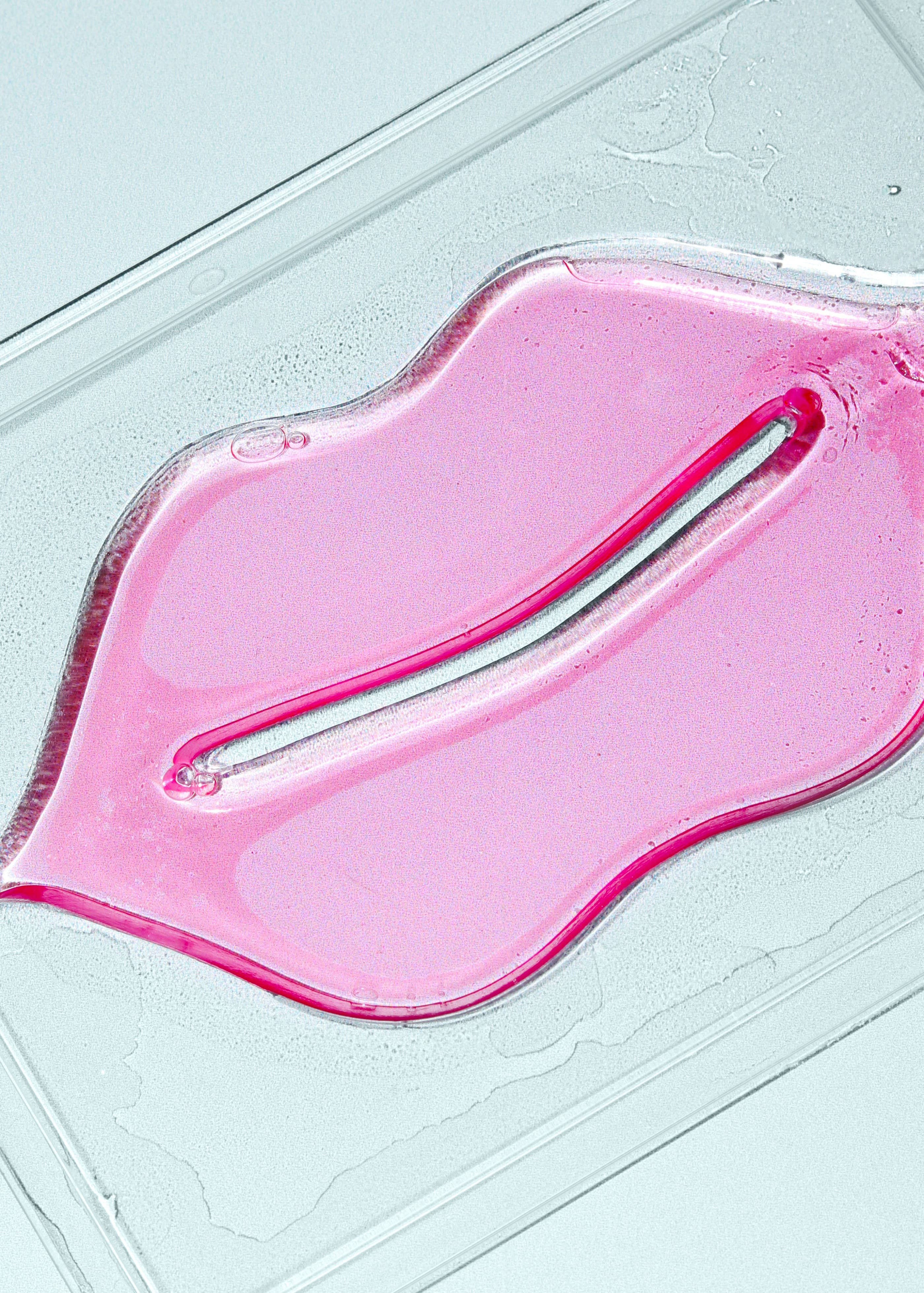 Pink gel-like substance on a light blue surface