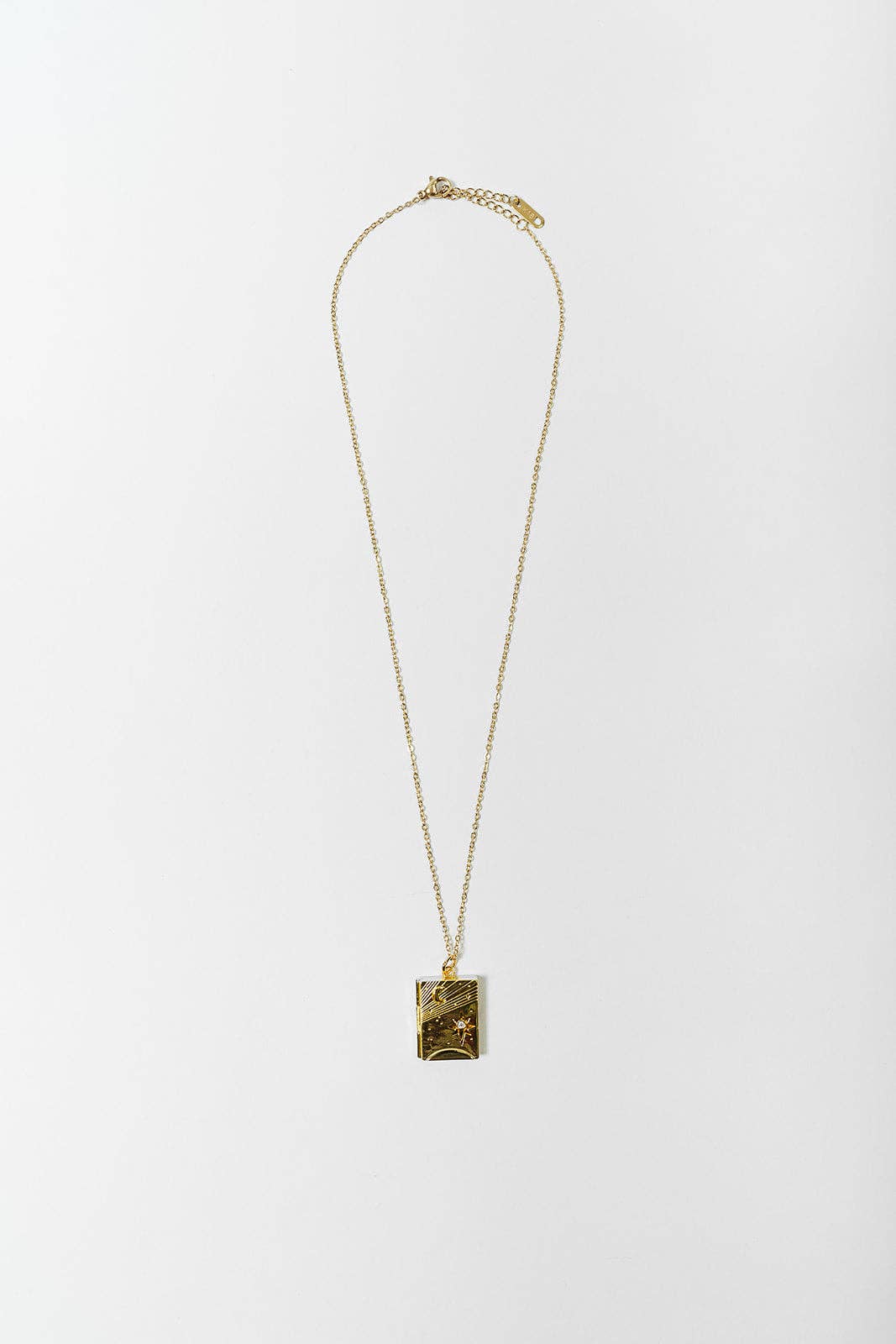 A gold chain necklace with a square pendant featuring a textured, abstract gold and black pattern, displayed against a clean white background.