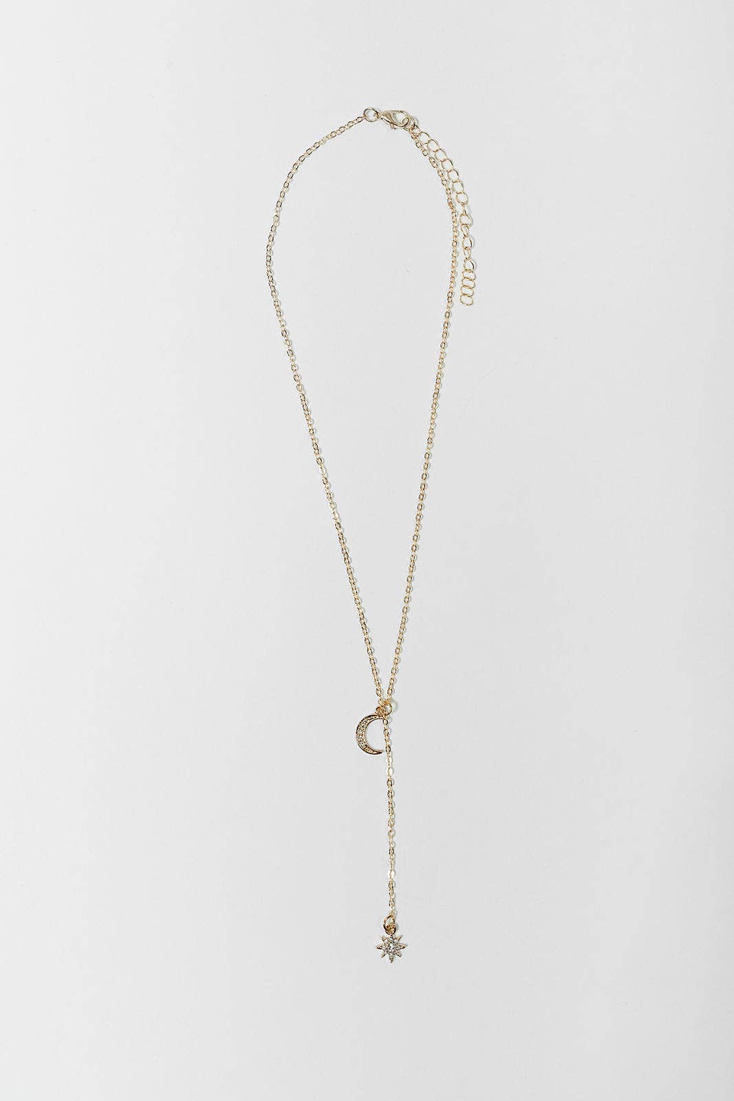 A delicate gold chain necklace featuring a crescent moon pendant and a dangling starburst charm, displayed on a clean white background.