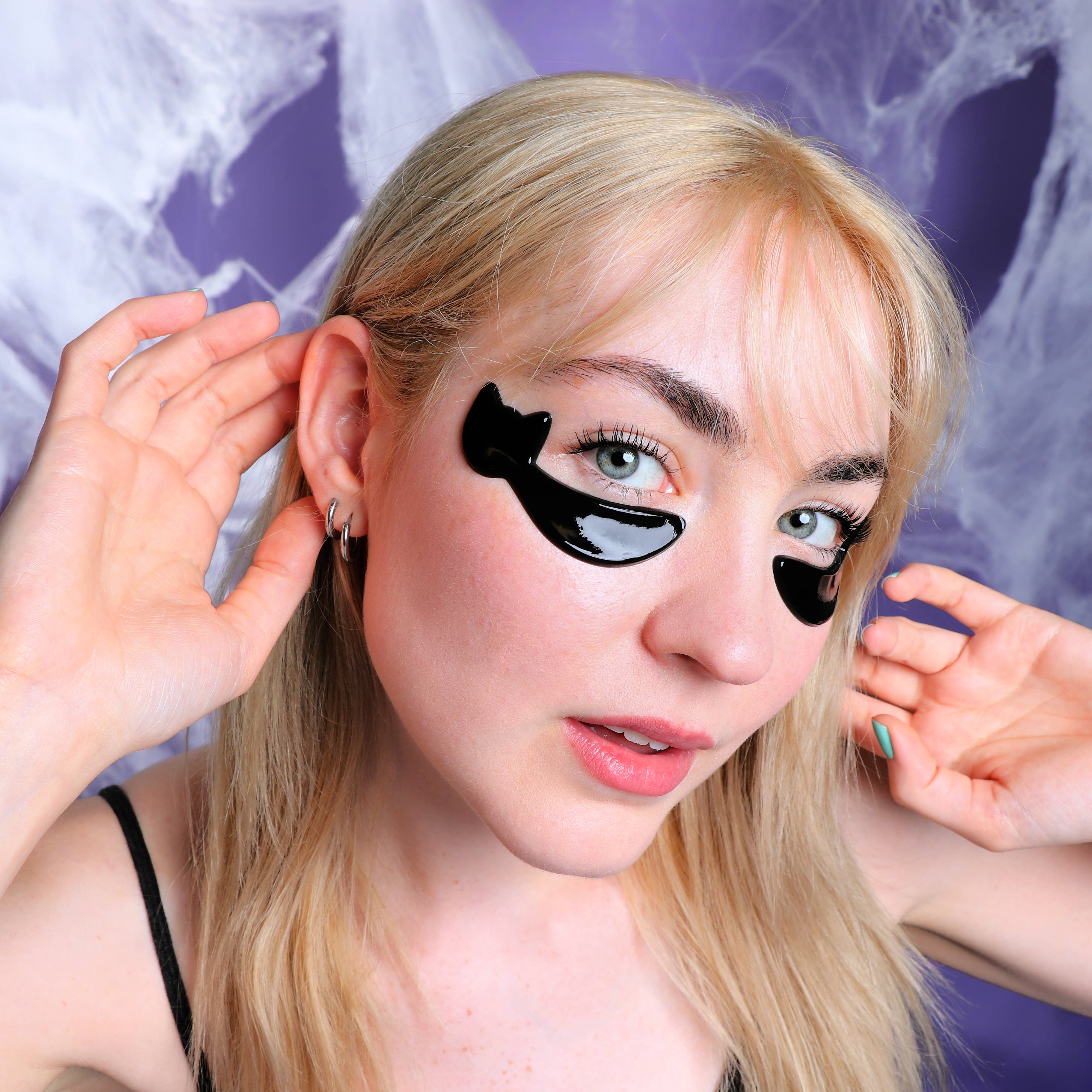 Woman with black eye patches on a purple background