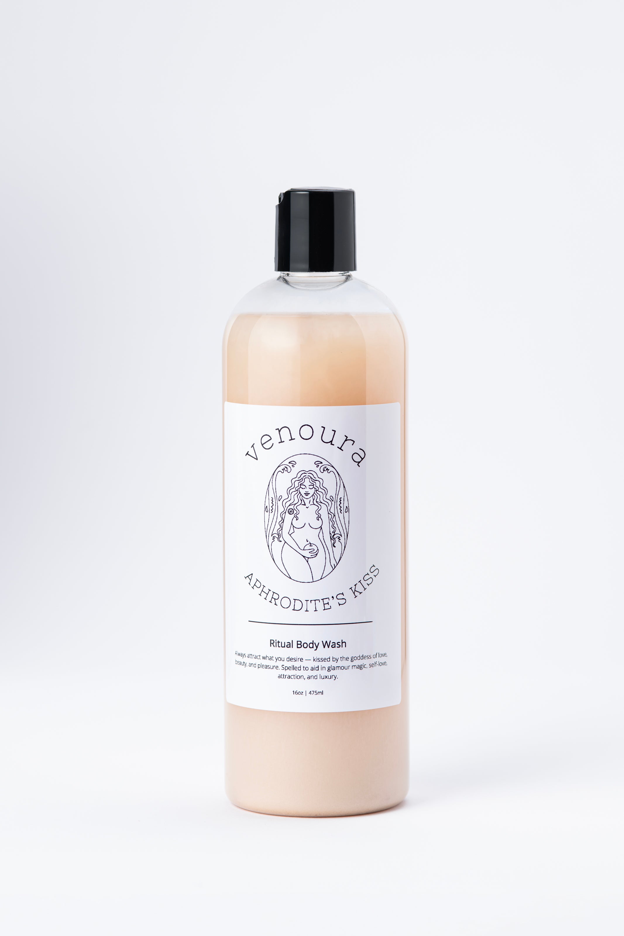 Venoura Aphrodite's Kiss Ritual Body Wash in a clear plastic bottle with a black cap, showing the light peach-colored liquid inside, set against a plain white background.