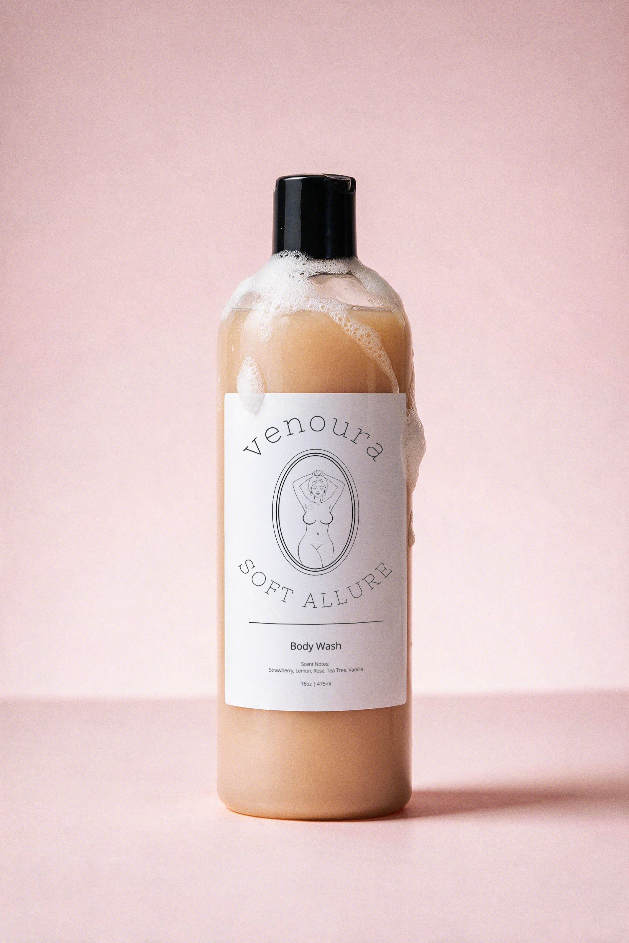 Venoura Soft Allure body wash in a clear plastic bottle with a black cap, filled with a light peach-colored liquid and topped with white foam, set against a solid pink background.