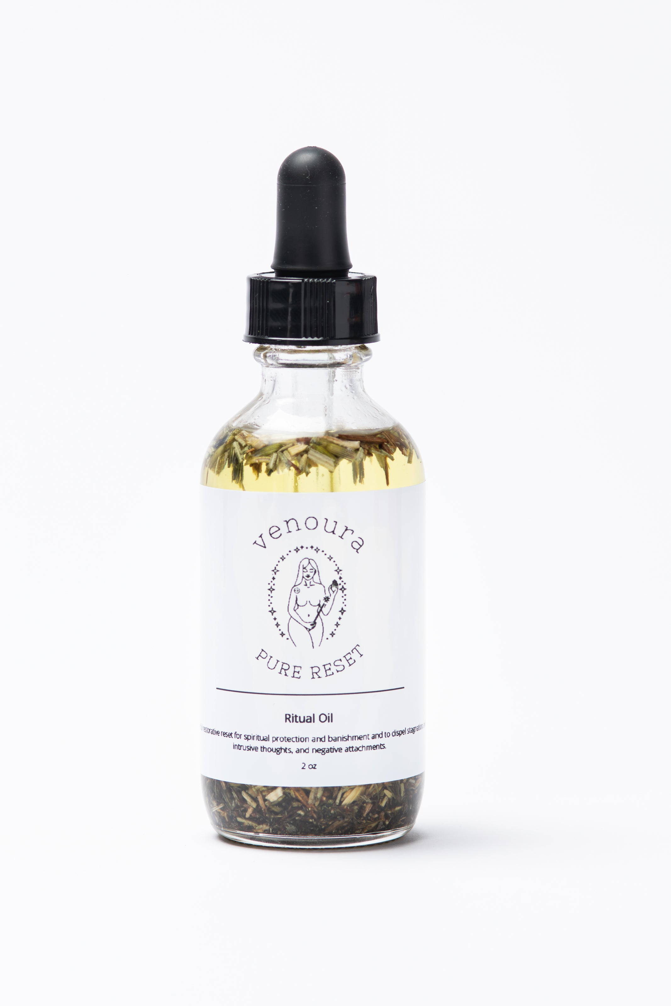 Venoura Pure Reset Ritual Body Oil used for spiritual protection, banishment, evil eye, and nourishing, moisturising  in a clear glass dropper bottle with a black cap, containing pale yellow oil and visible dried botanicals at the bottom, on a white background.