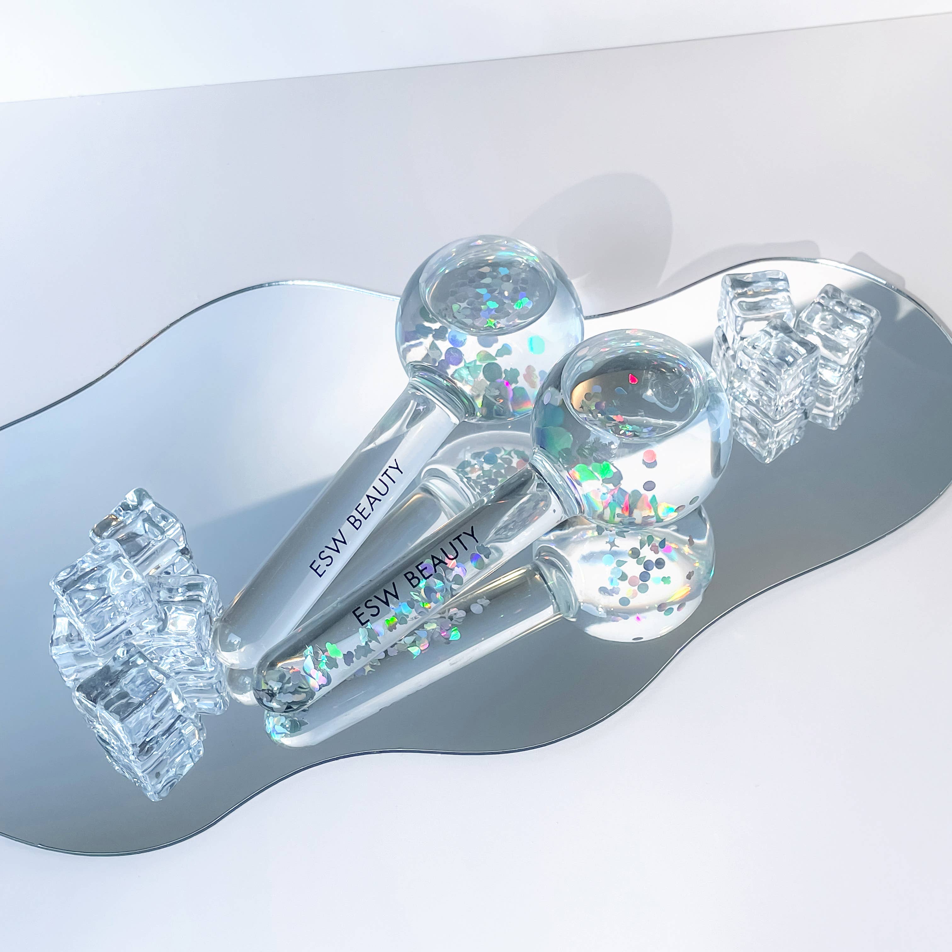 ESW Beauty skincare product with glittery elements on a reflective surface