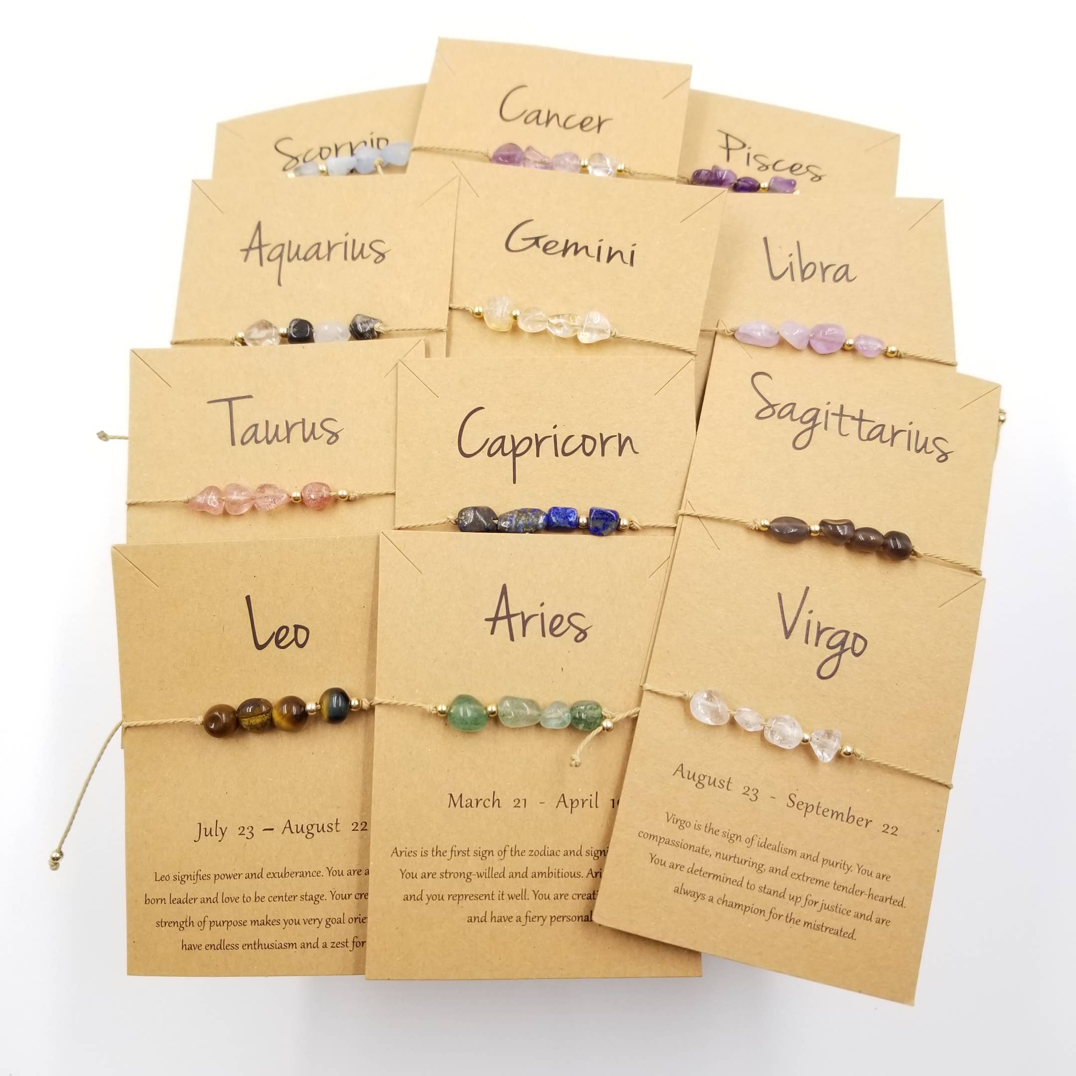Set of zodiac bracelets on personalized cards with names of zodiac signs.