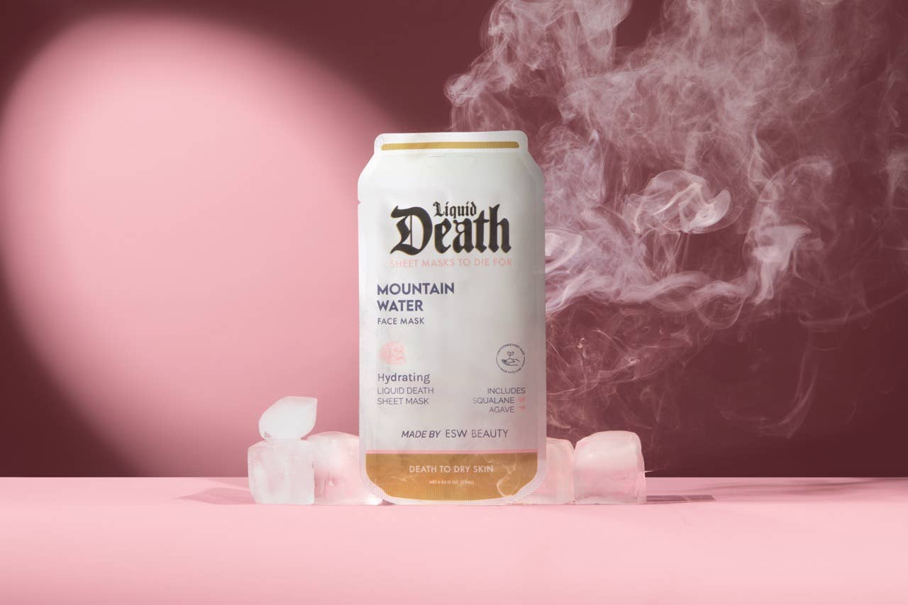 Can of 'Liquid Death' mountain water with ice cubes and smoke effect on a pink background