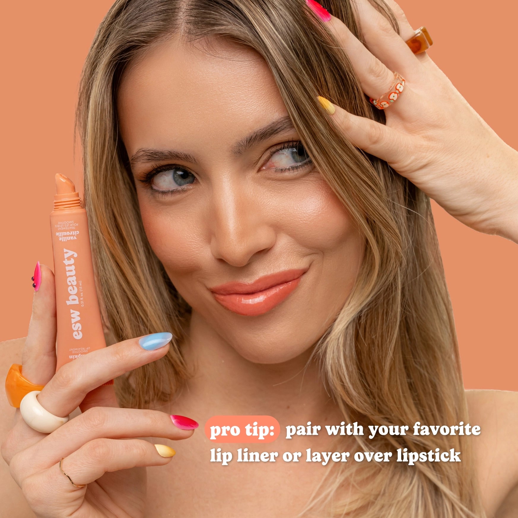 Woman holding a makeup product with text on an orange background